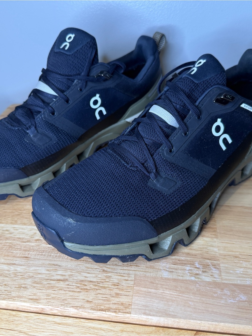 On Waterproof Men's Trail Shoes in midnight blue and Olive